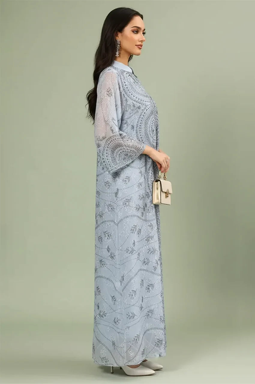Side profile of the Kaly Light Blue sheer maxi kaftan demonstrating the fluid drape and wide flared sleeve design.