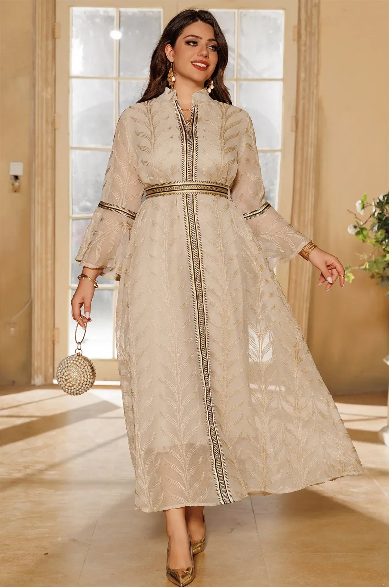 Full-length walking pose of a woman wearing the ivory beige Kitala Kaftan, emphasizing the light and airy sheer organza fabric.