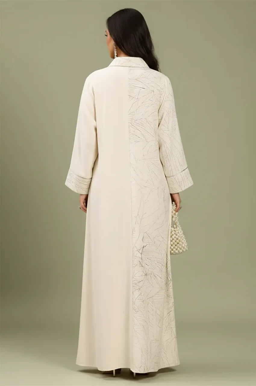 Rear view of the Lamiya beige a line kaftan dress showcasing the graphic leaf print panel and modest floor-length silhouette.