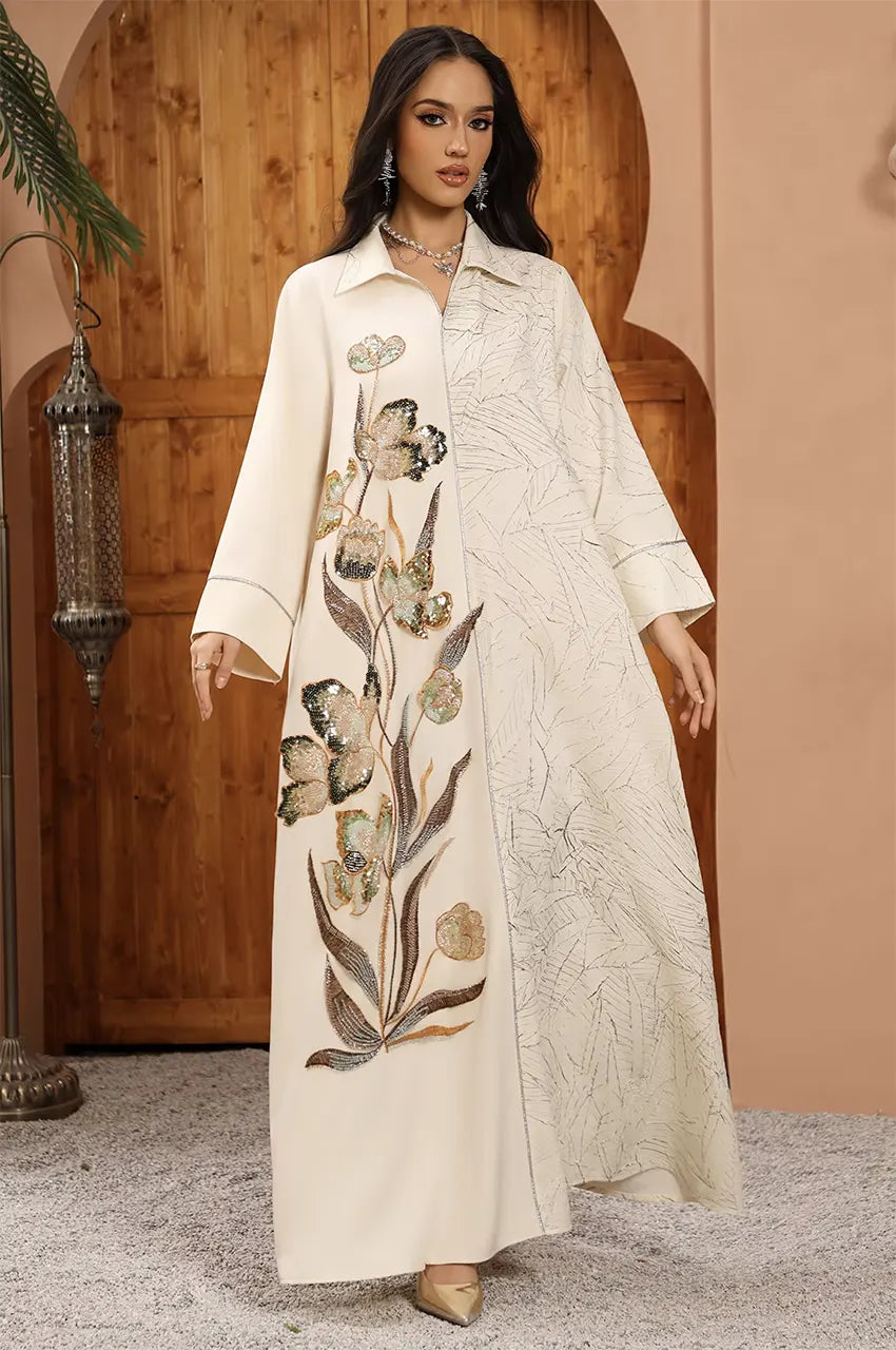 Naylara Lamiya beige a line kaftan dress showcasing the artistic contrast between the plain ivory side and the botanical leaf print.