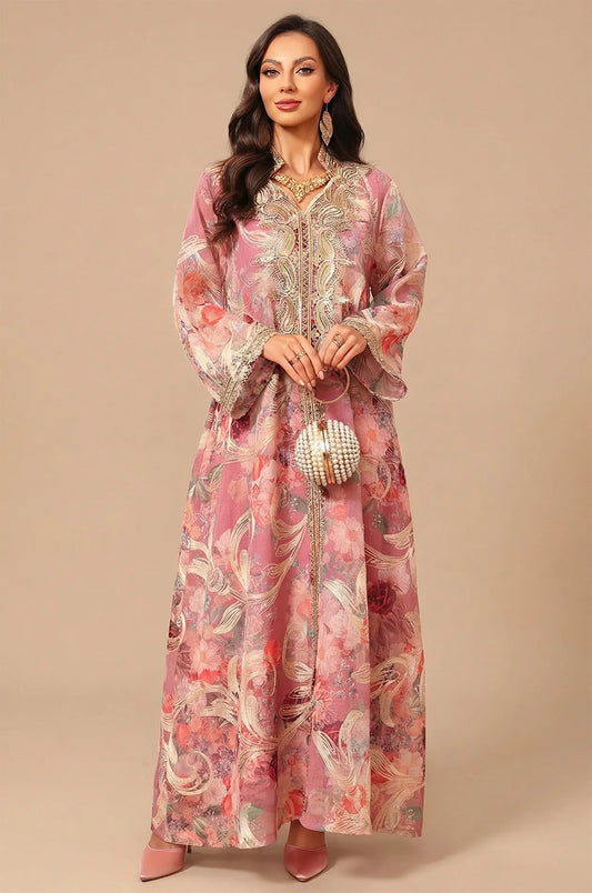 Full-length front view of the Naylara Lyrae pink vintage embroidered kaftan with rose floral print and a pearl-beaded circular handbag.