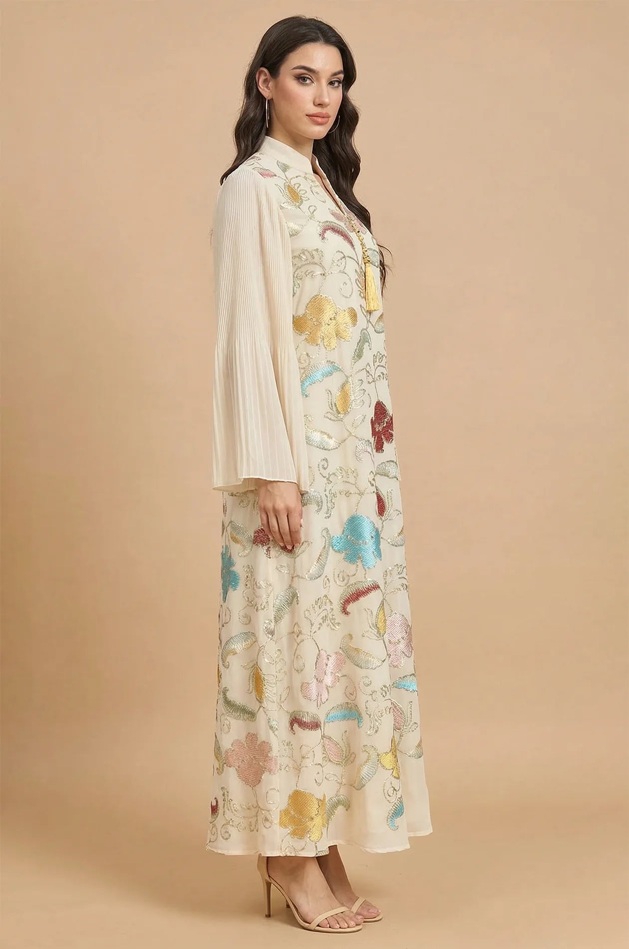 Side profile of the Marylin Beige Kaftan showcasing the elegant pleated bell sleeves and flowy floor-length silhouette.