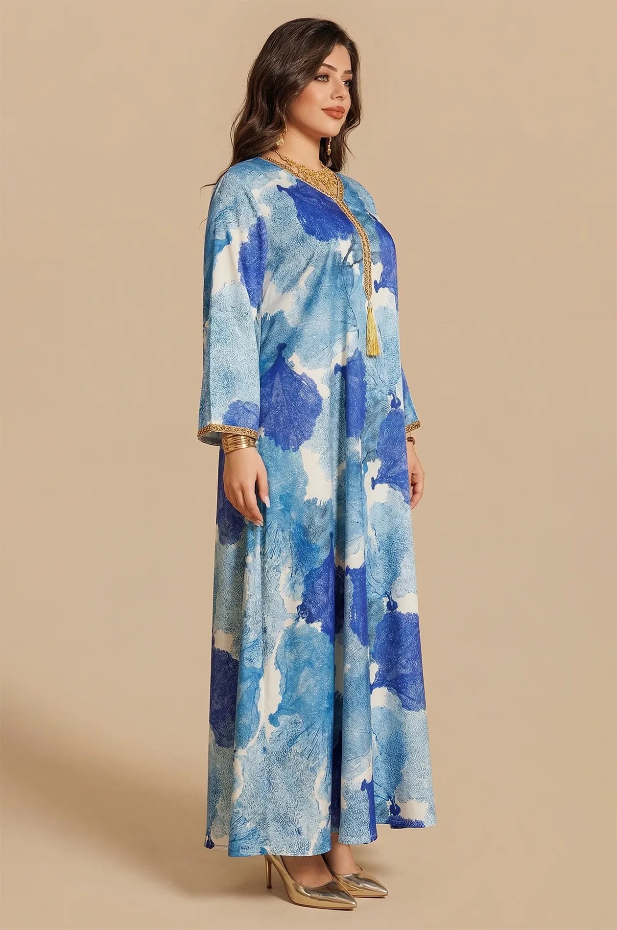 Side profile shot of the Navae blue tropical print kaftan showcasing the flowing sleeve design.