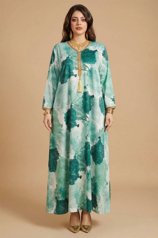Studio front view of the Navae green tropical print kaftan featuring the signature gold tassel and braided neckline.