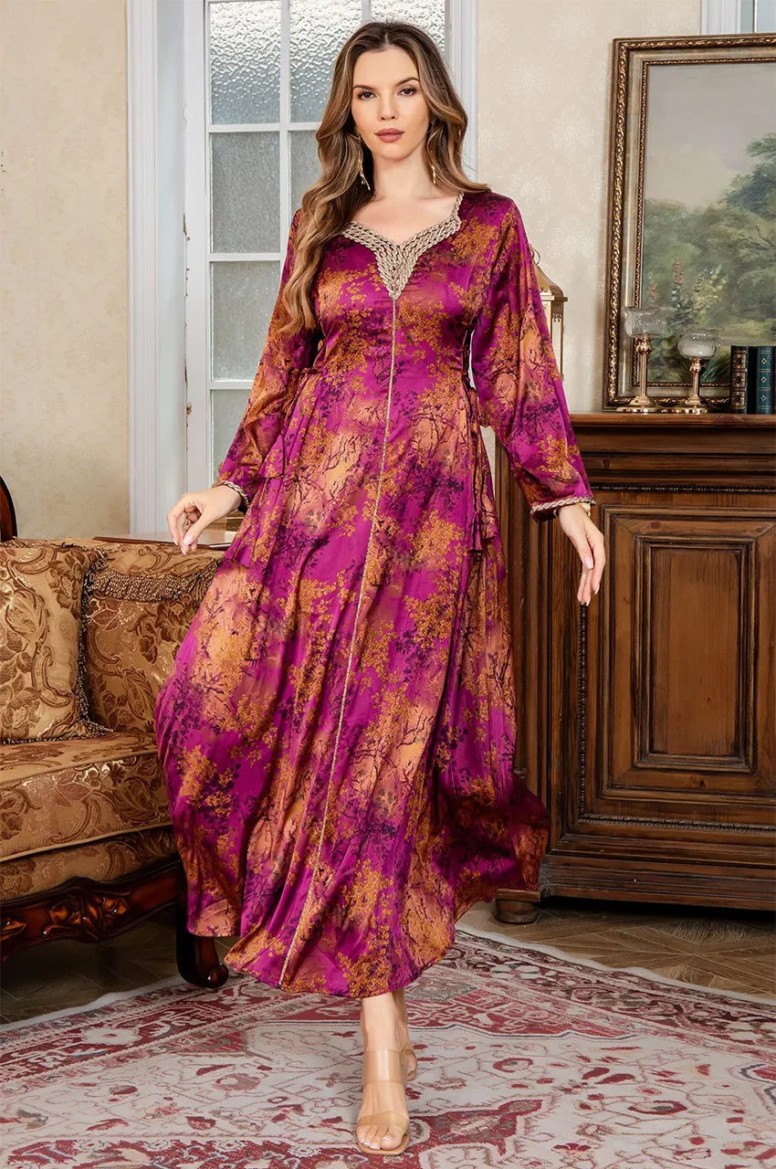 Standing motion shot of the fuchsia red Noria fitted kaftan highlighting the flared bell sleeves and golden accents.