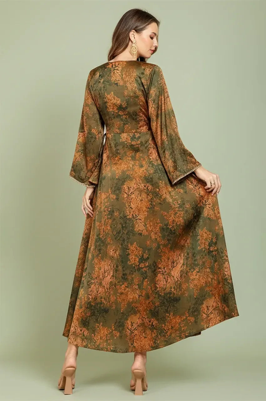 Back view of the Noria olive green fitted kaftan highlighting the flowy silhouette and intricate botanical print.