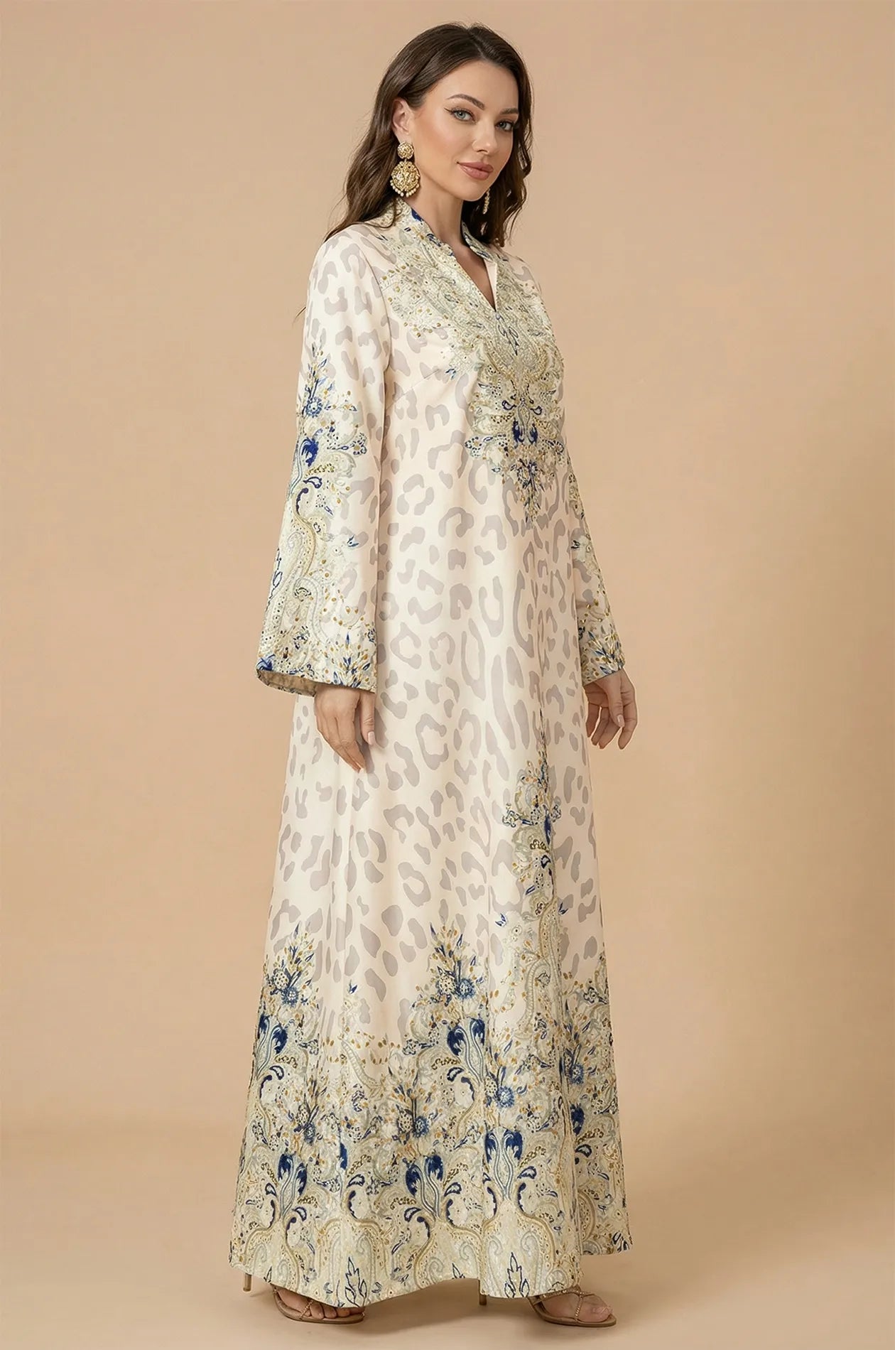 Side profile of the Nyx White Leopard Print Kaftan, highlighting the graceful drape of the lightweight satin-blend fabric and floor-length fit.