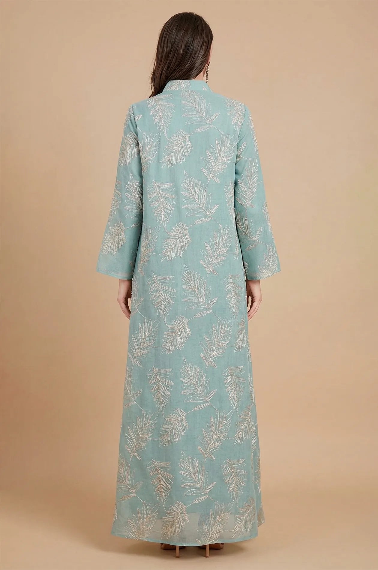 Back view of the Saria gray kaftan showing the full-length sheer fabric and intricate silver leaf patterns.