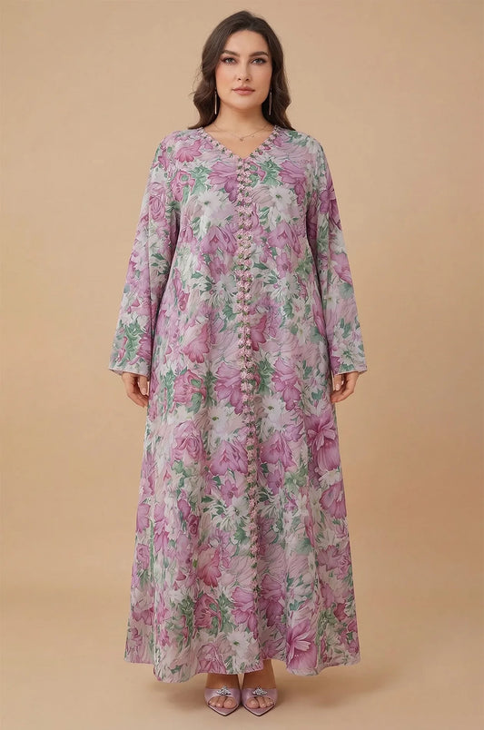 Studio portrait of the Suri light pink kaftan showing the V-neckline and floral pattern.