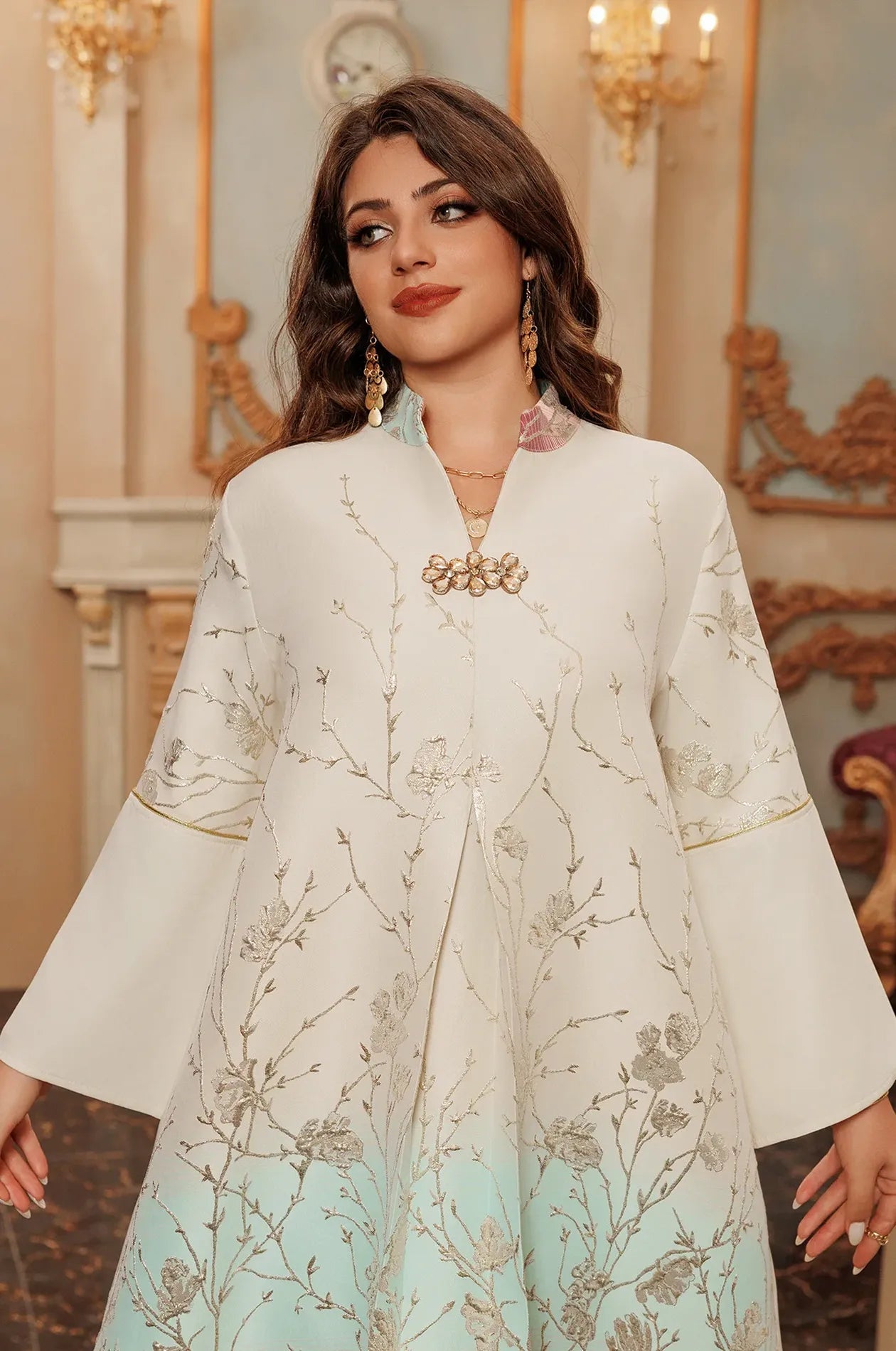 Portrait view of the Tayla Red Botanical Kaftan highlighting the mandarin collar and the signature crystal-encrusted brooch.