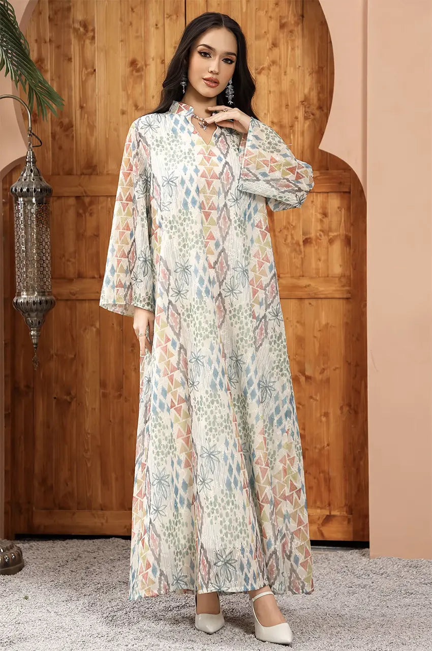 Elegant pose featuring the Tyrah white geometric print kaftan from Naylara with a focus on fluid drape.