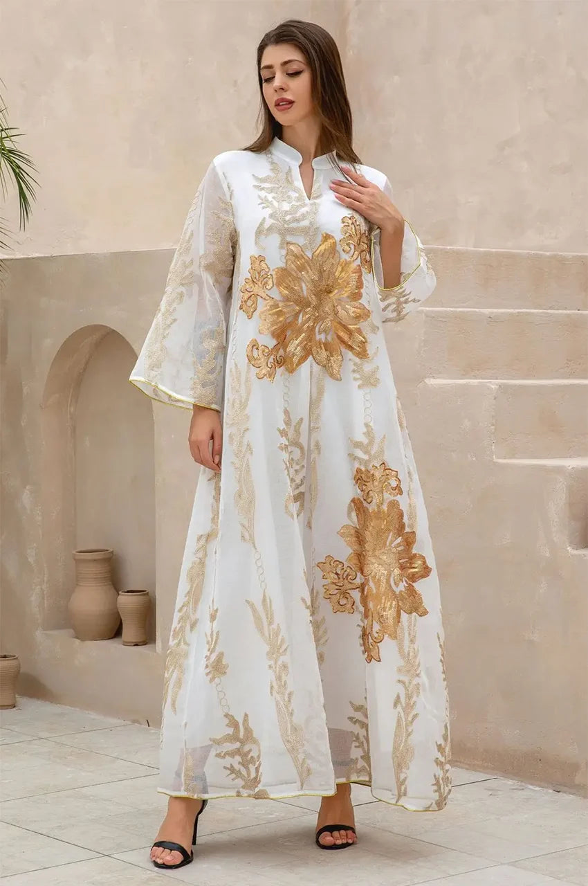 Full-length walking pose in the white Maliya flower kaftan showcasing luxury resort wear style.