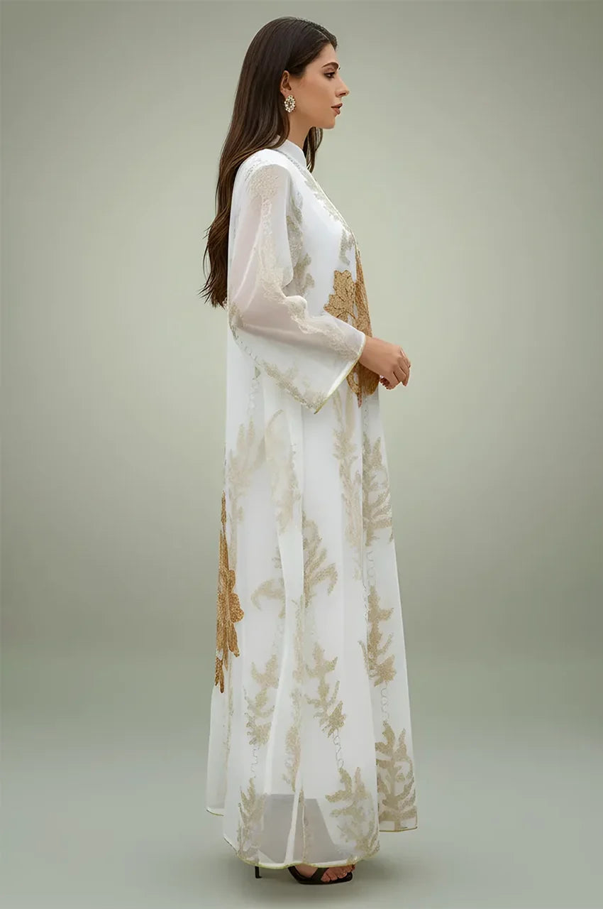 Side profile of the white Maliya flower kaftan showing the bell sleeve detail and gold metallic floral appliquΓ©.