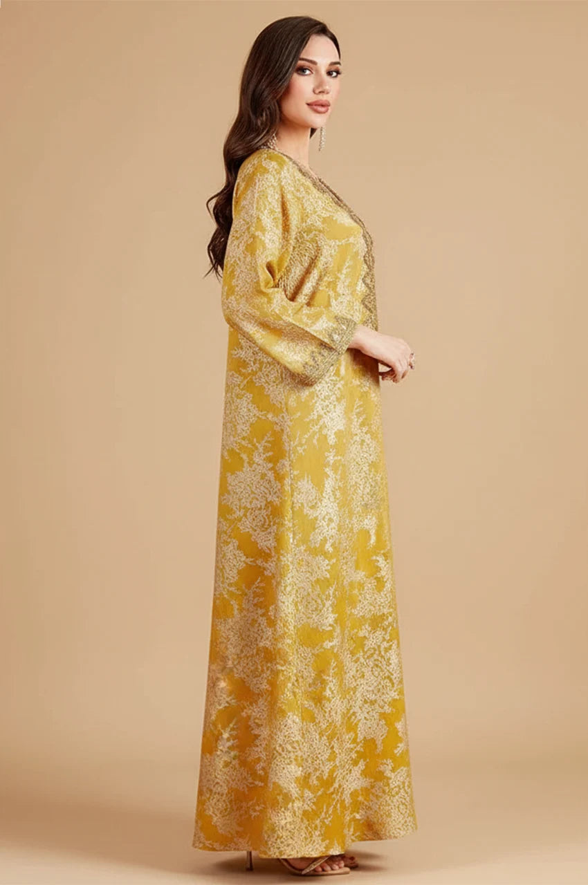 Side profile of mustard yellow Zafra kaftan showing long wide sleeves and modest cut.