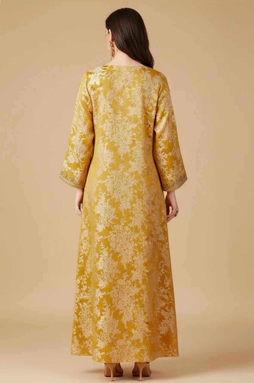 Rear view of elegant mustard yellow Moroccan kaftan dress with white floral motifs.