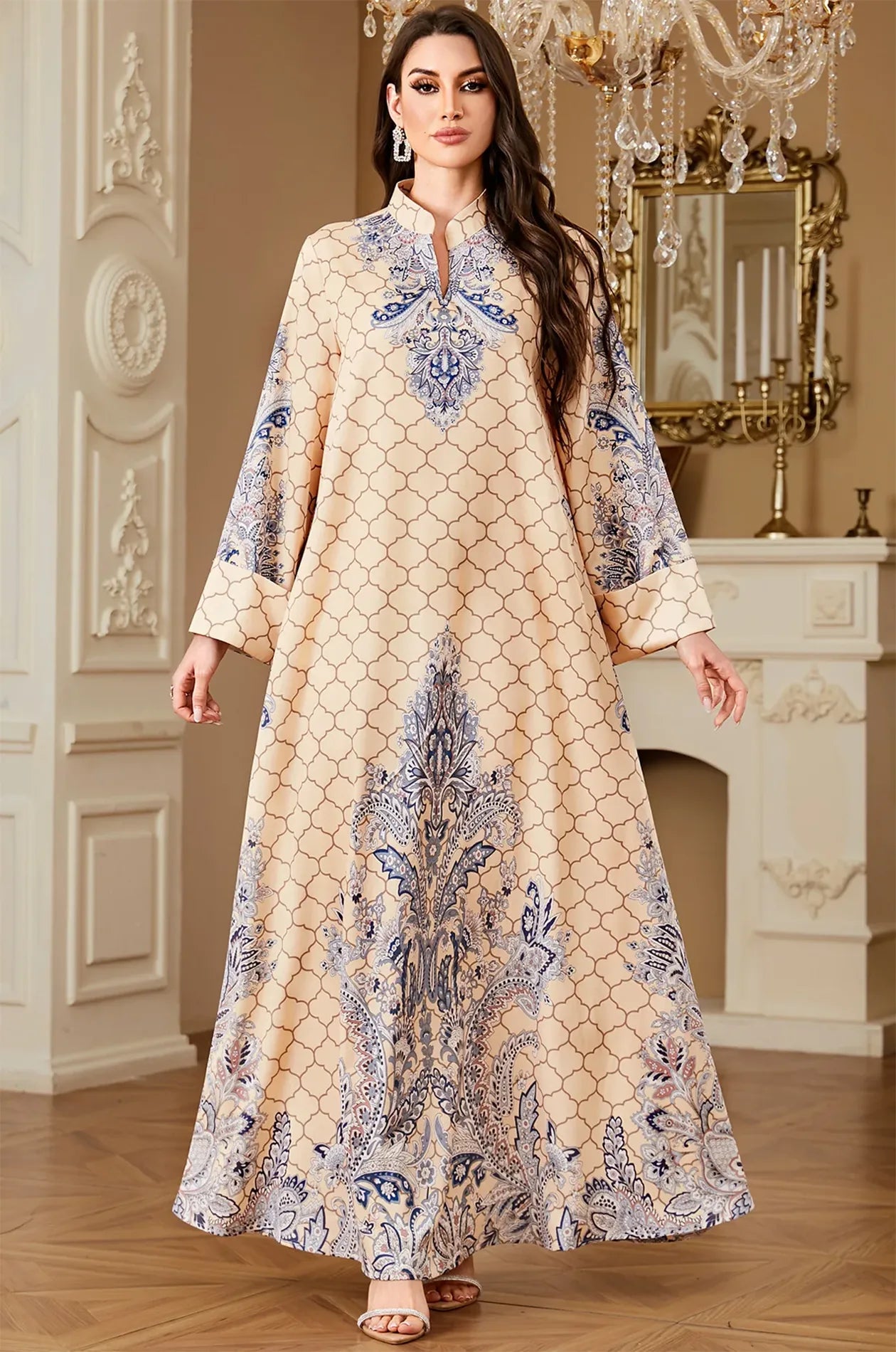 Elegant view of the Nirea beige paisley print kaftan by Naylara, featuring a floor-length silhouette and ornate blue arabesque detailing.