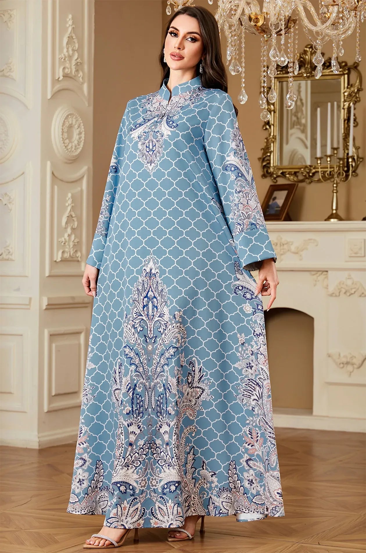 Full-length view of the Nirea blue paisley print kaftan from Naylara, showcasing the ornate blue floral border and regal movement.