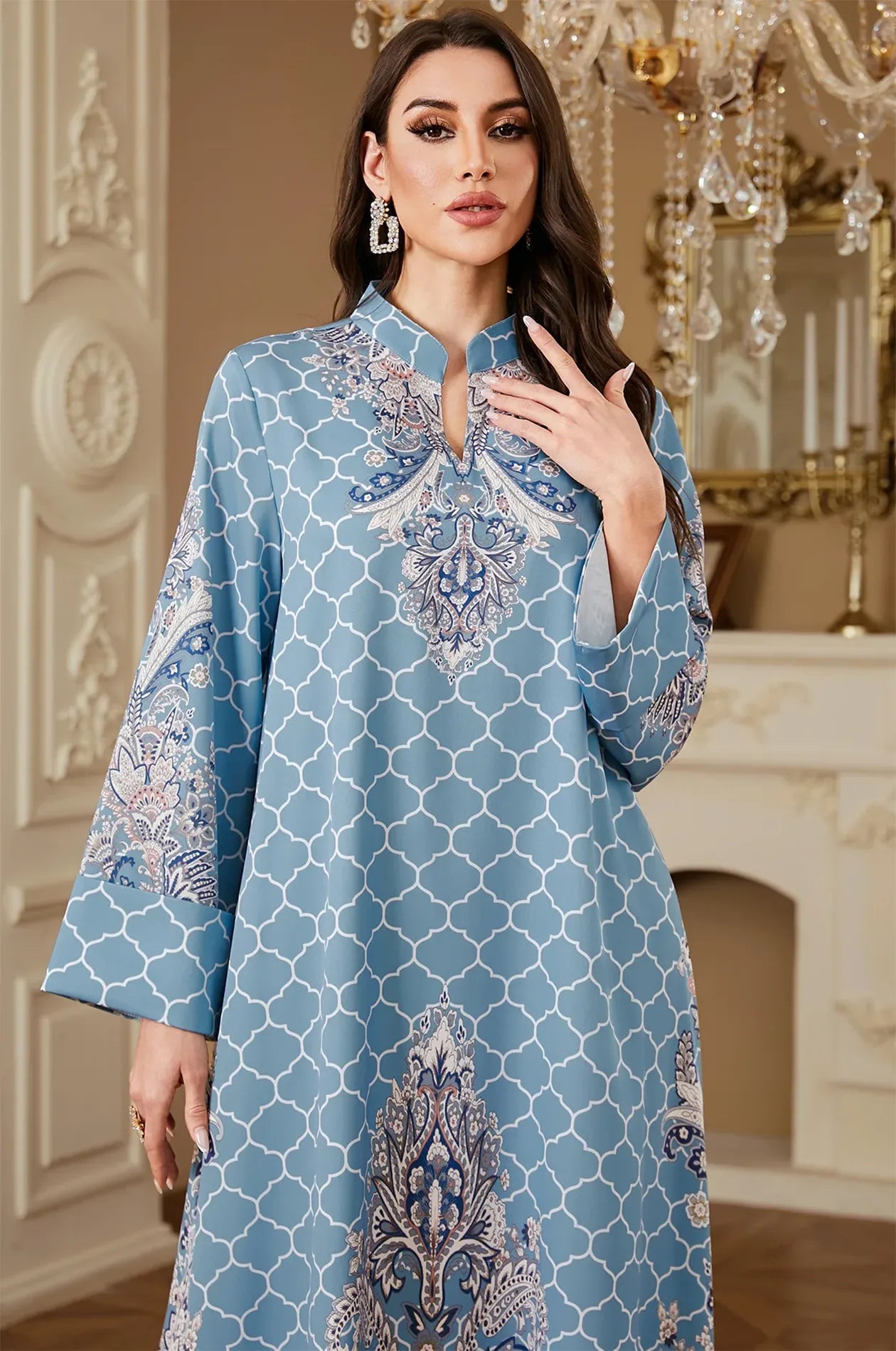 Close-up of the Nirea blue paisley print kaftan by Naylara, showing the elegant mandarin collar and intricate white lattice pattern.