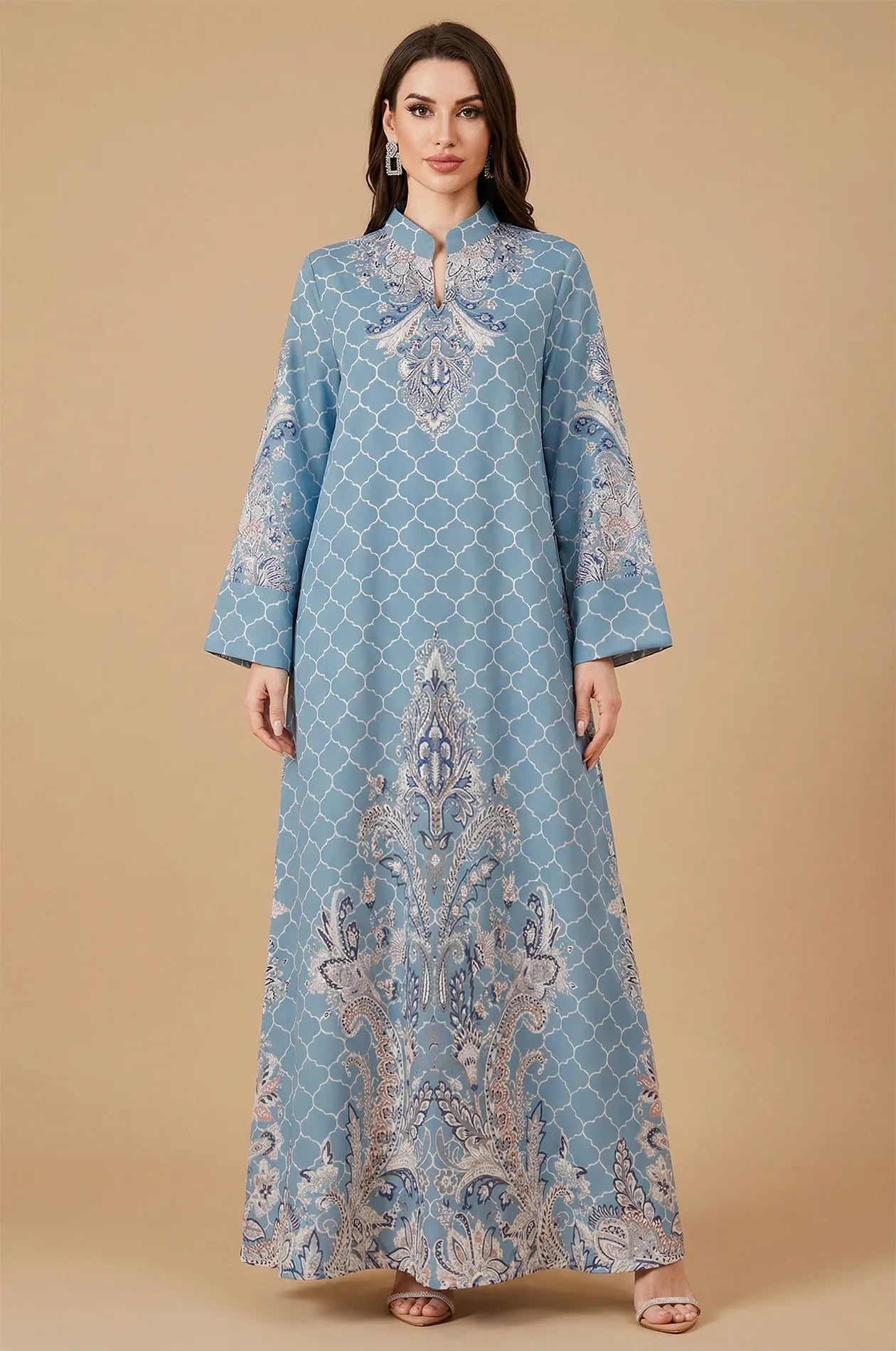 Professional studio shot of the Nirea blue paisley print kaftan, displaying the vibrant azure color and symmetrical floral patterns.