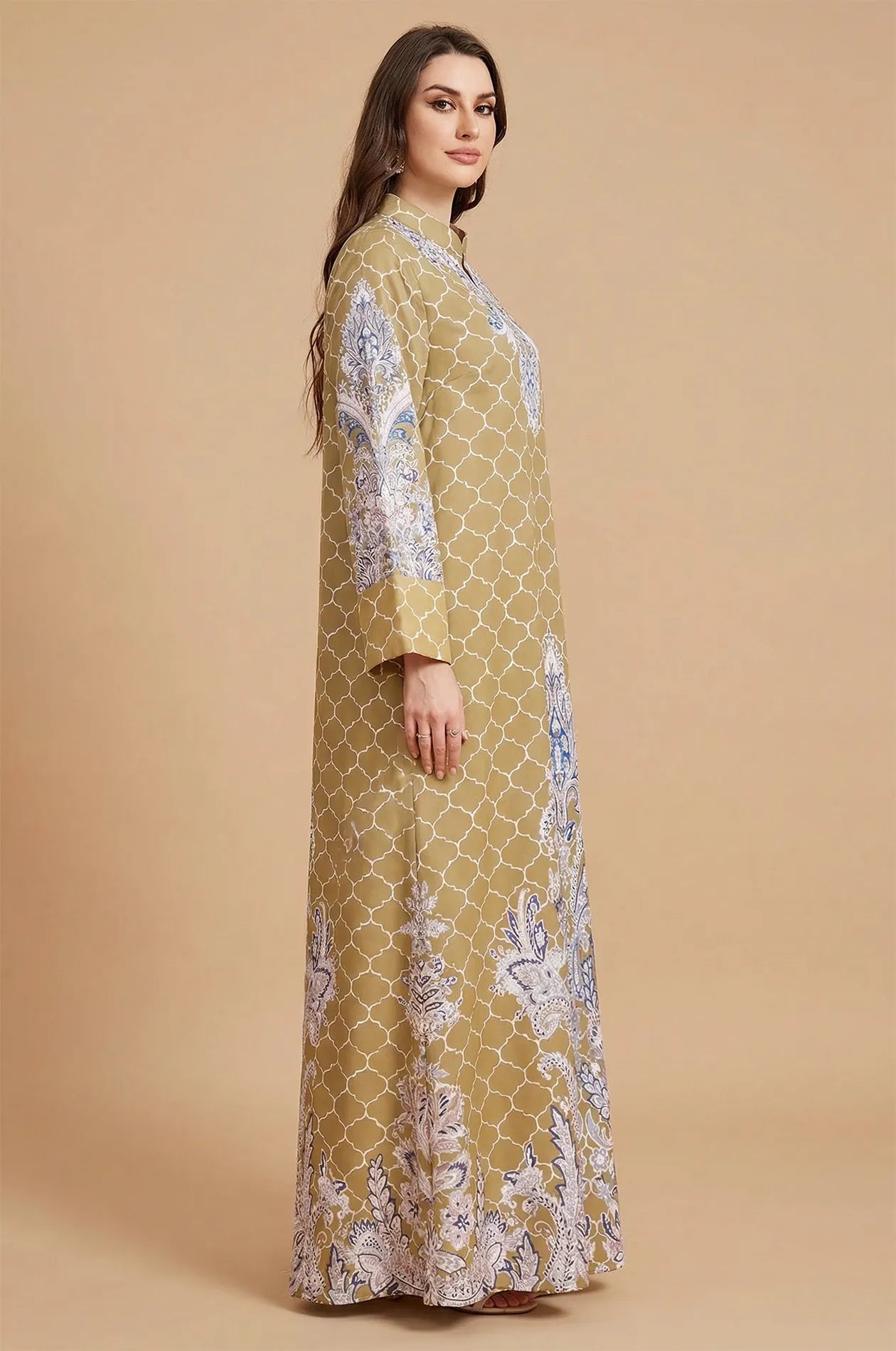 Side profile of the Nirea yellow paisley print maxi kaftan by Naylara, demonstrating the loose and fluid fabric drape.