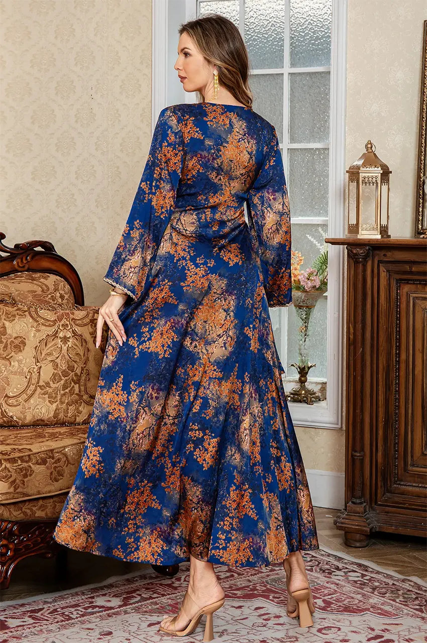 Lifestyle back shot of the Noria blue fitted kaftan highlighting the flowy silk-blend fabric.