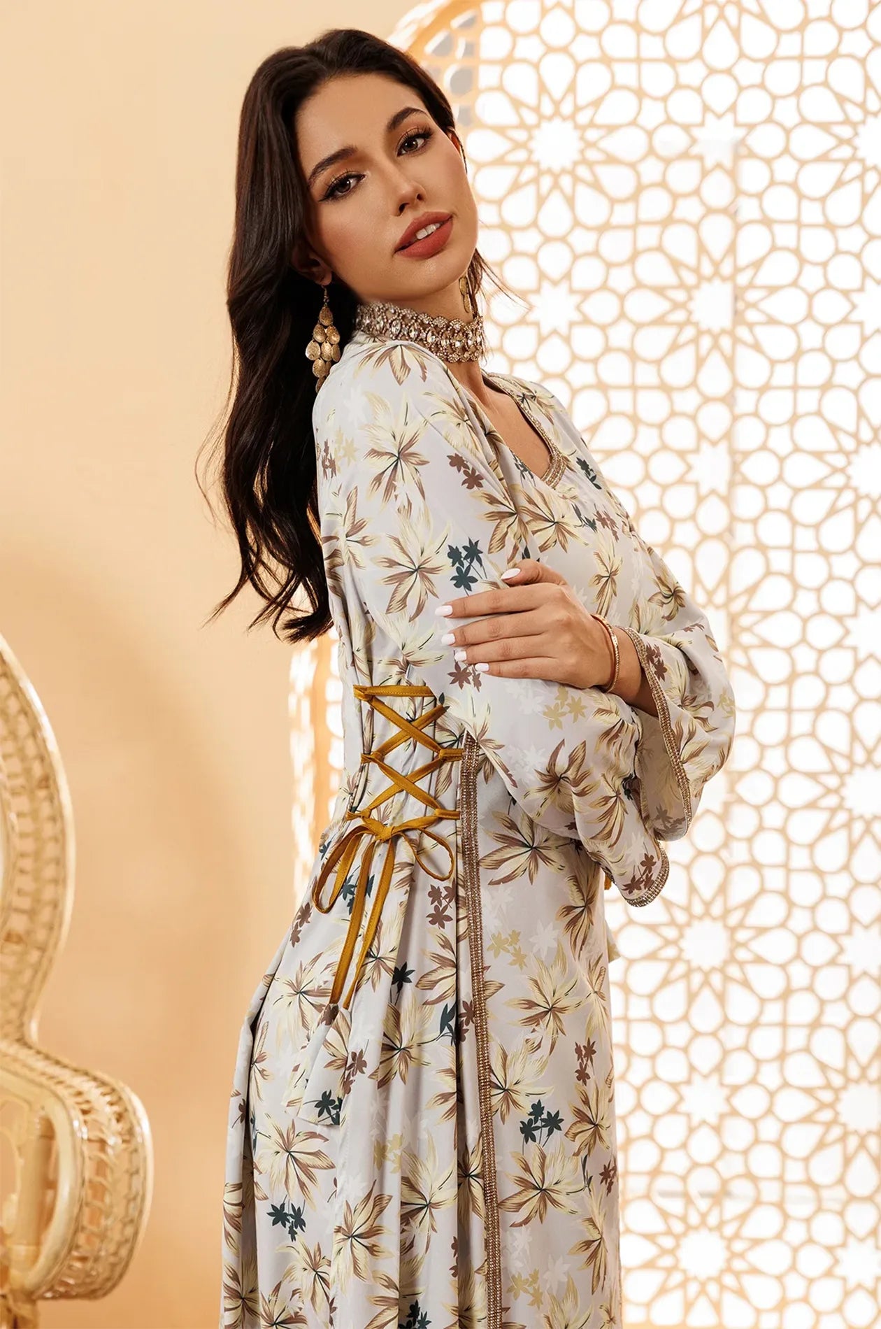 Close-up of the metallic gold trim and side-lace on the Nysria kaftan.