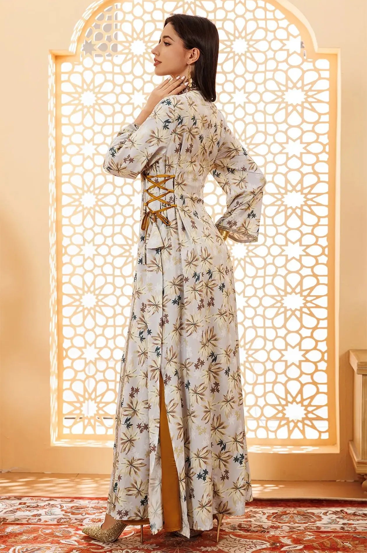 Model wearing Nysria boho kaftan standing in front of an architectural window.