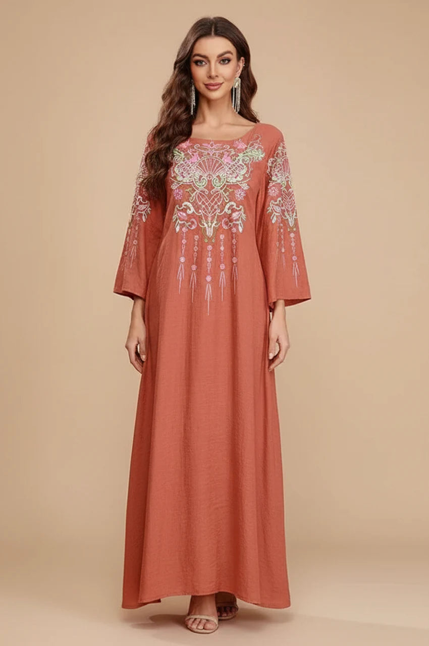 Full front view of Oraya burnt orange kaftan with floral embroidery on model.