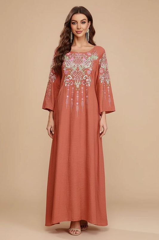 Full front view of Oraya burnt orange kaftan with floral embroidery on model.
