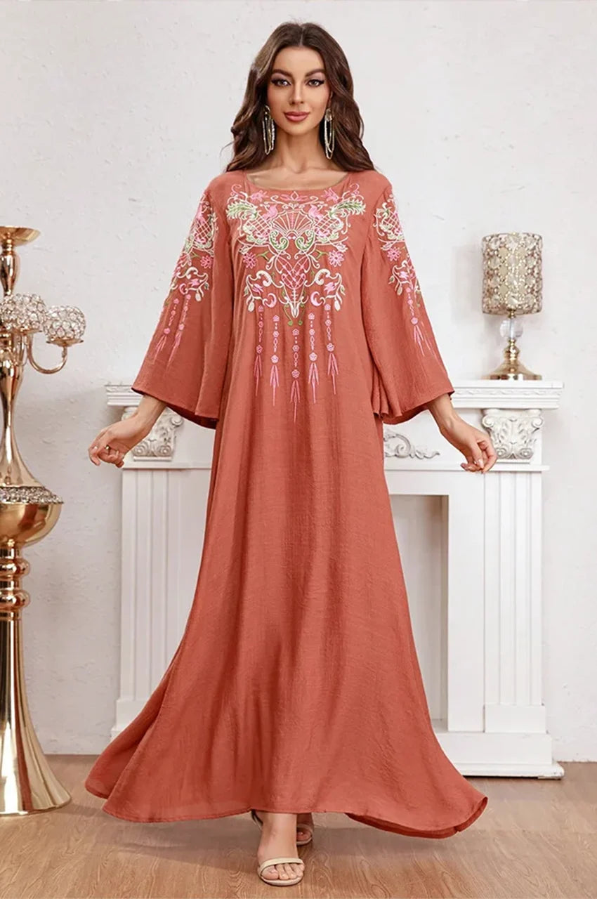 Model walking in Oraya burnt orange kaftan displaying A-line skirt movement.