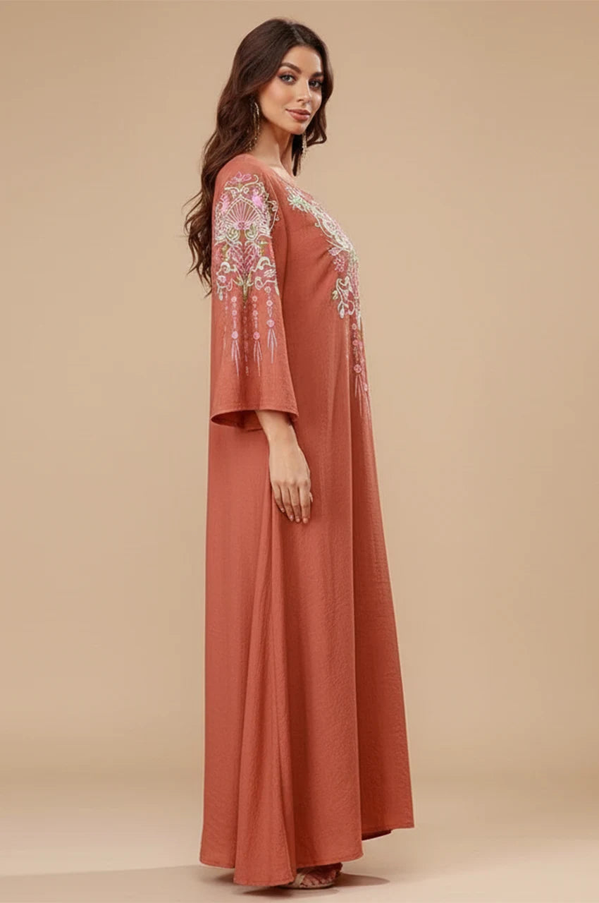 Side profile of woman wearing Oraya burnt orange kaftan showing sleeve drape.