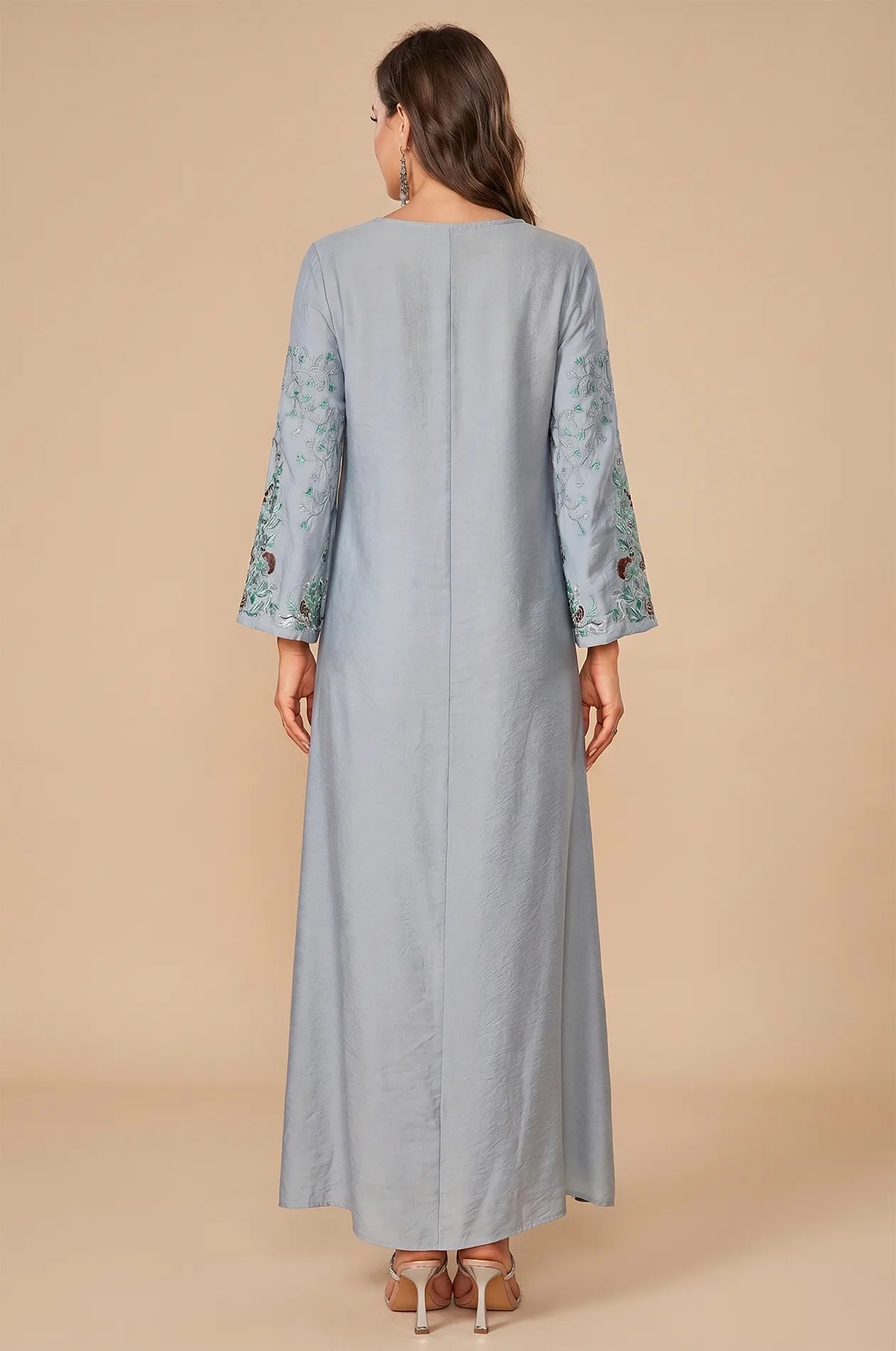 Rear view of the Petra dusty blue kaftan showing the fluid drape.