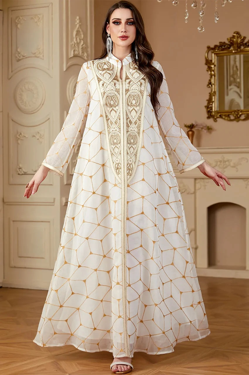 Model posing in Rahel premium white kaftan displaying fabric movement and gold detailing.