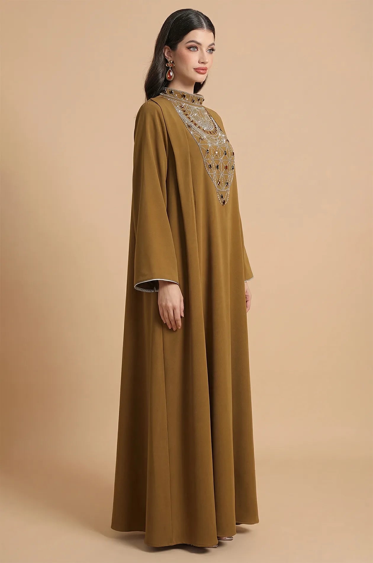 Side profile of the Rami crystal kaftan showcasing the high neck and sleeve drape.