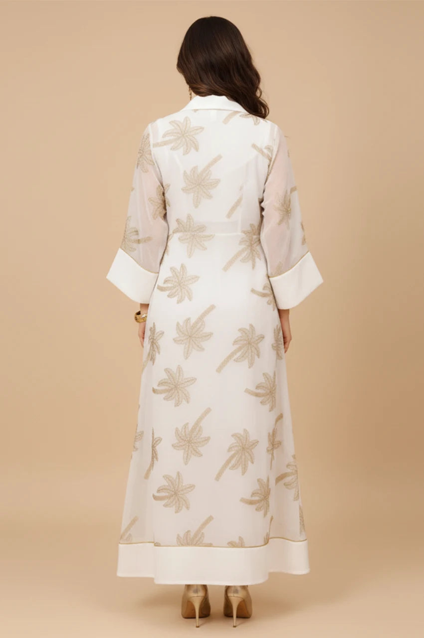 Back view of the SAELA white palm tree kaftan showcasing the floor-length fluid drape.