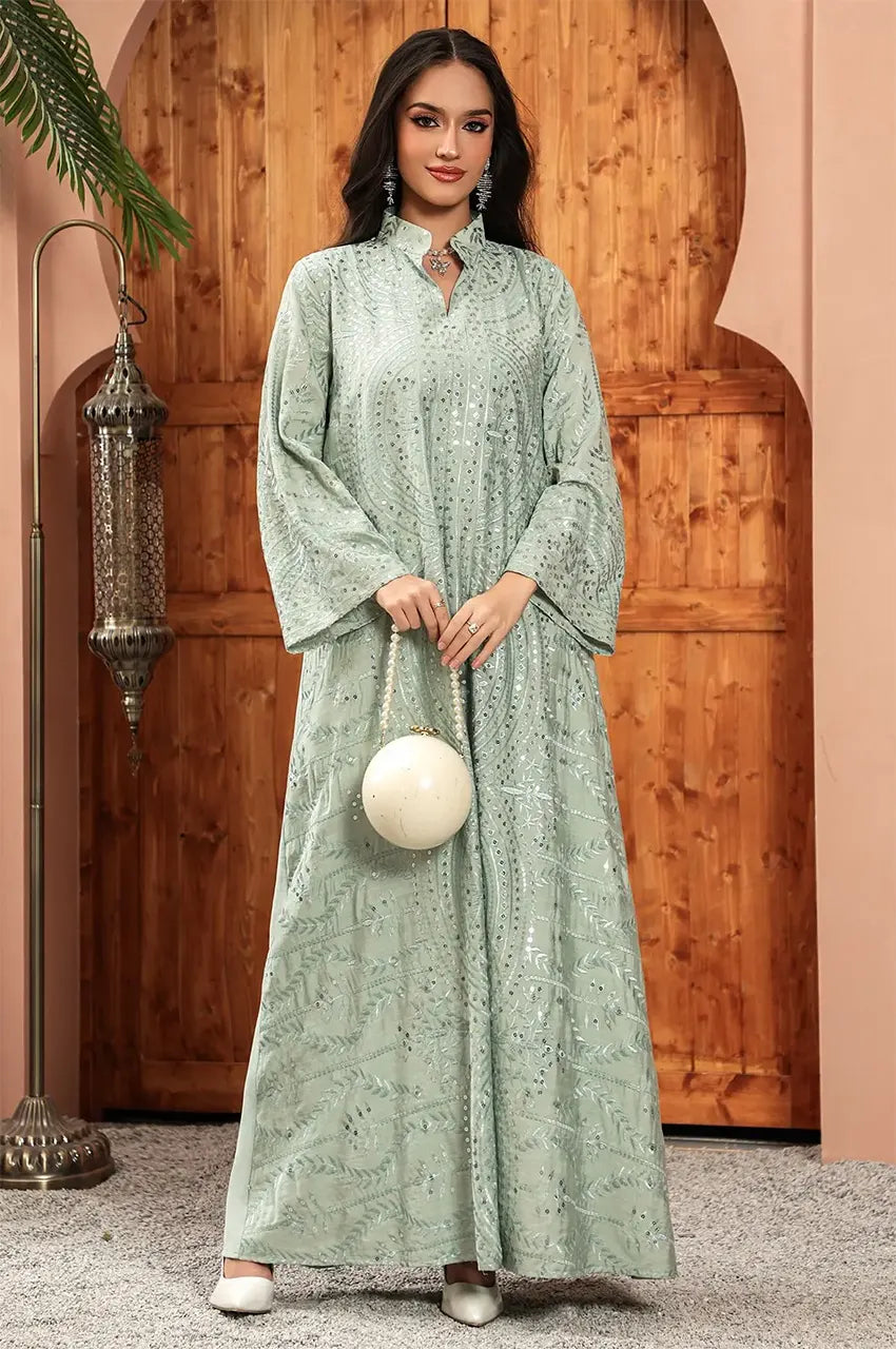 Frontal shot of the Maeli Kaftan styled with a decorative white spherical clutch bag.