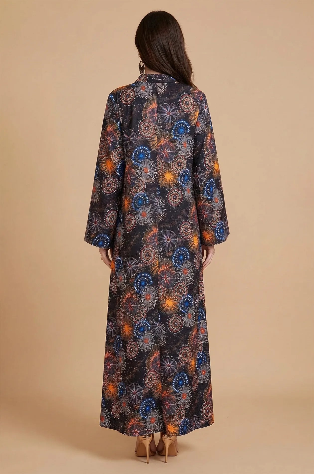 Back view of the flowing Samia celestial kaftan showing the continuous starburst pattern.