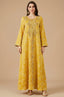 Full front view of the Selas Yellow textured kaftan dress with gold embroidery on a tan studio background.