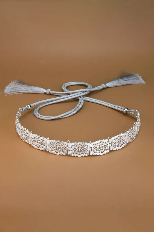Full view of the Silver Square Filigree Belt with grey adjustable rope ties on a beige background.