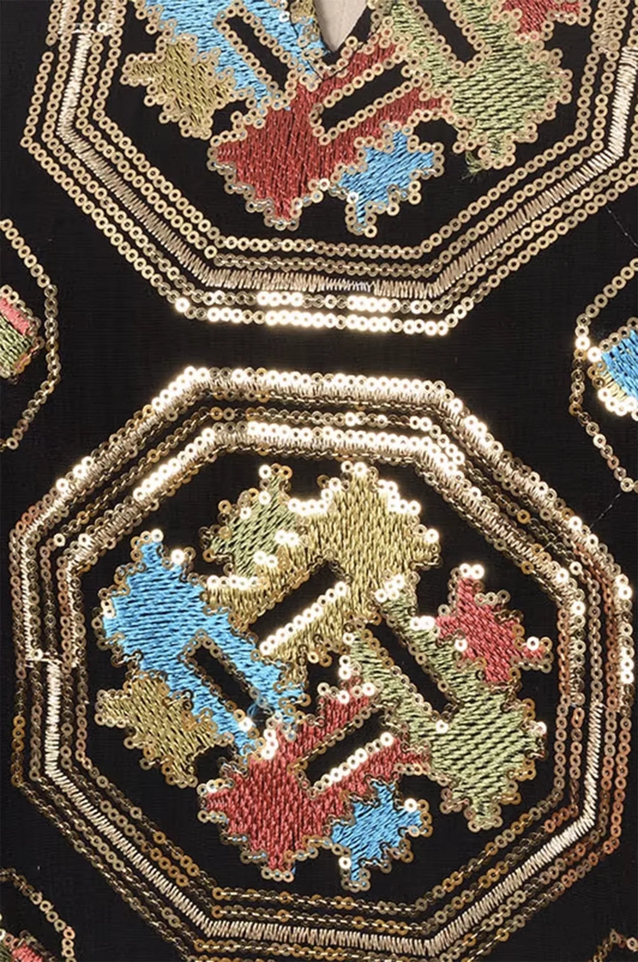Close-up macro shot of the gold sequins and colorful geometric embroidery on the Sorin black mandarin collar kaftan.