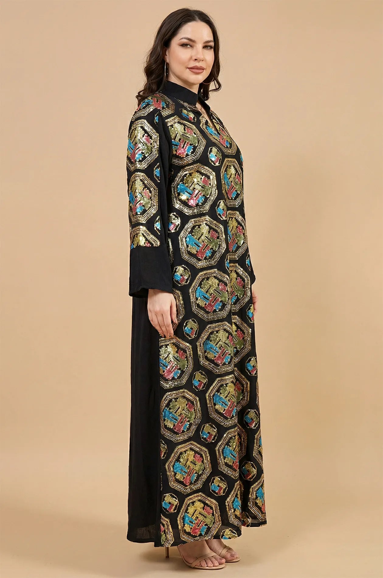 Side profile of the Sorin black mandarin collar kaftan featuring gold geometric embroidery and a floor-length silhouette.