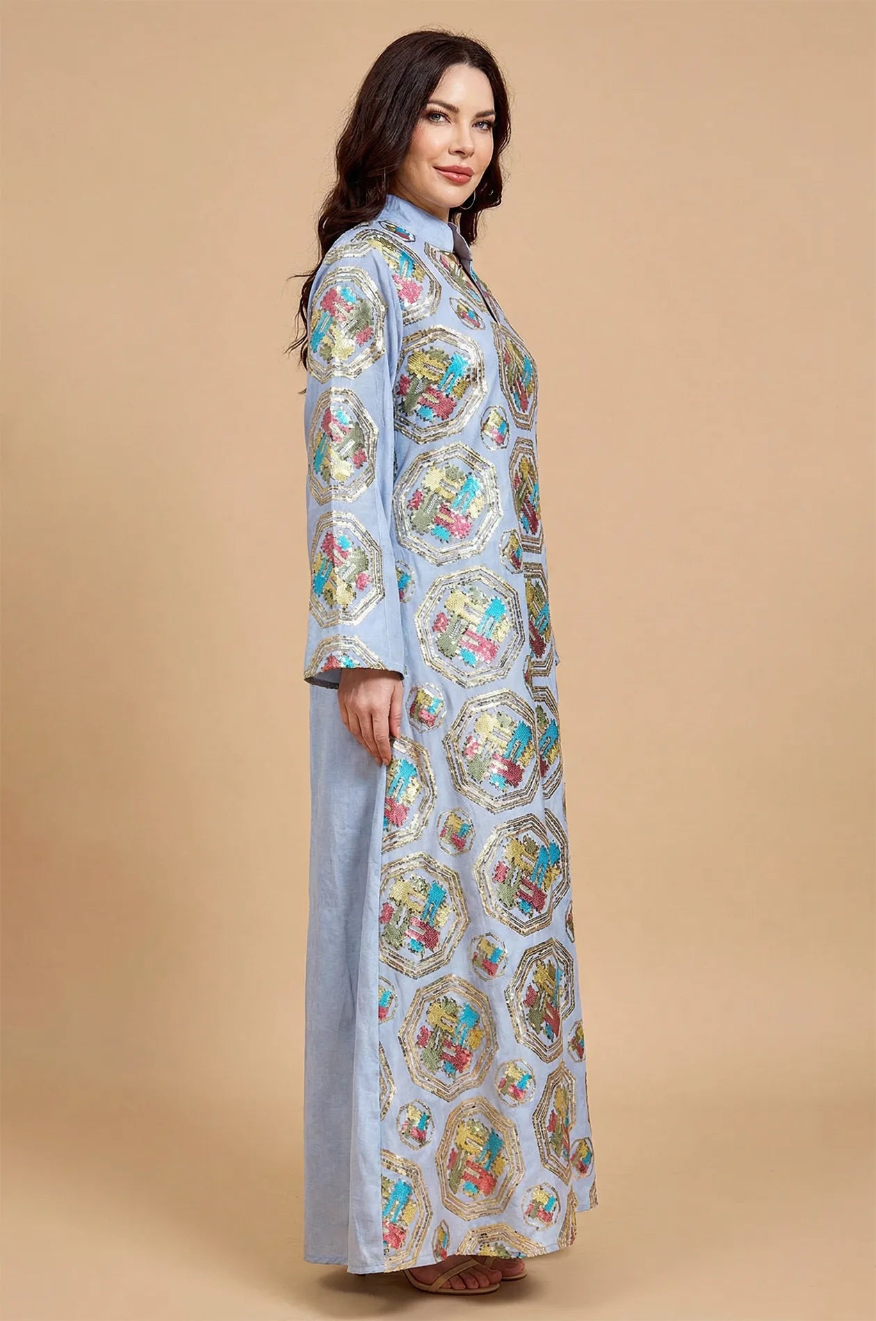 Side profile of a model wearing the Sorin light blue kaftan, highlighting the floor-length silhouette and pattern continuity.