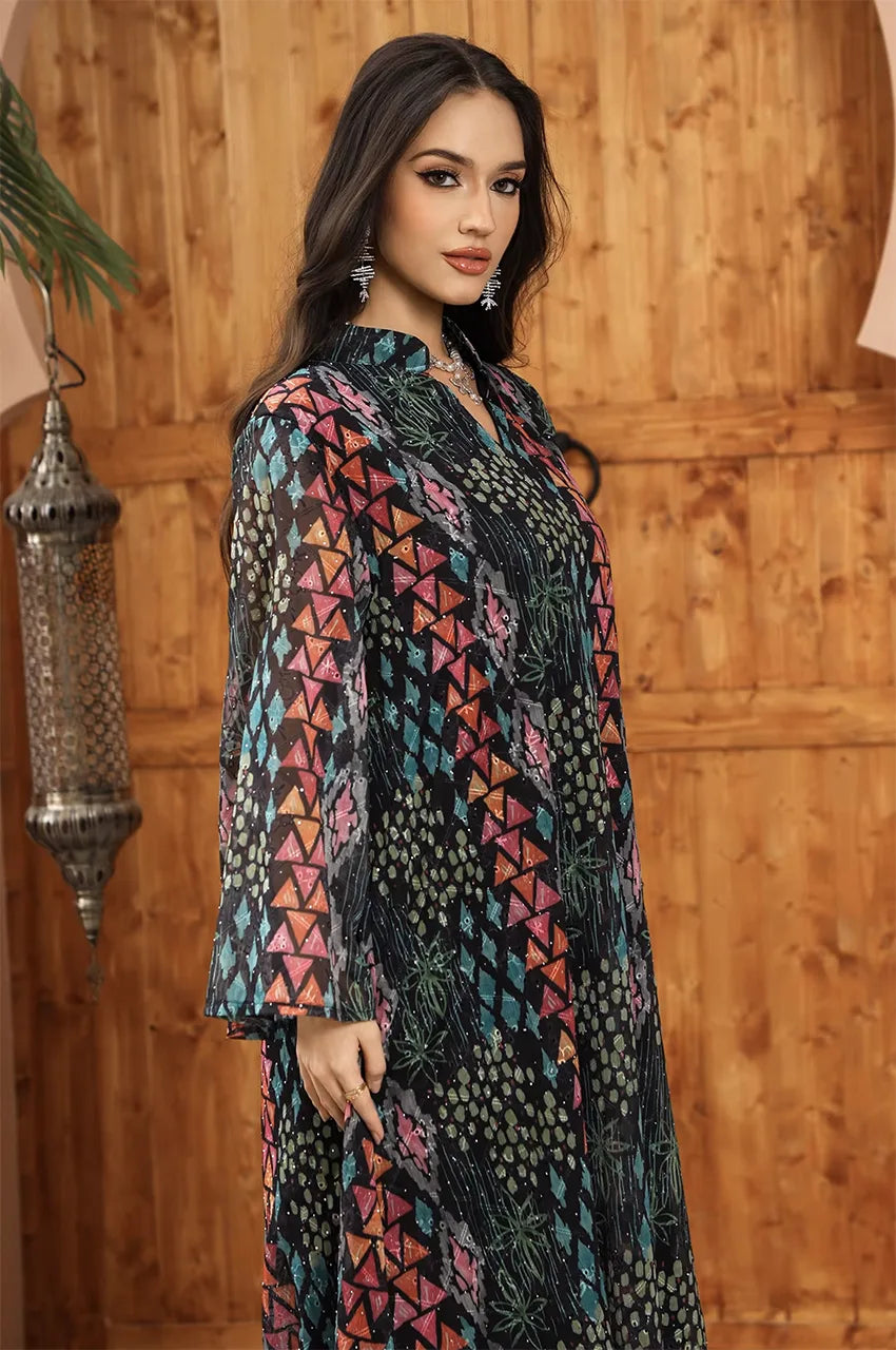 Angle view of the long sleeves and bodice pattern on the Tyrah black geometric print kaftan.