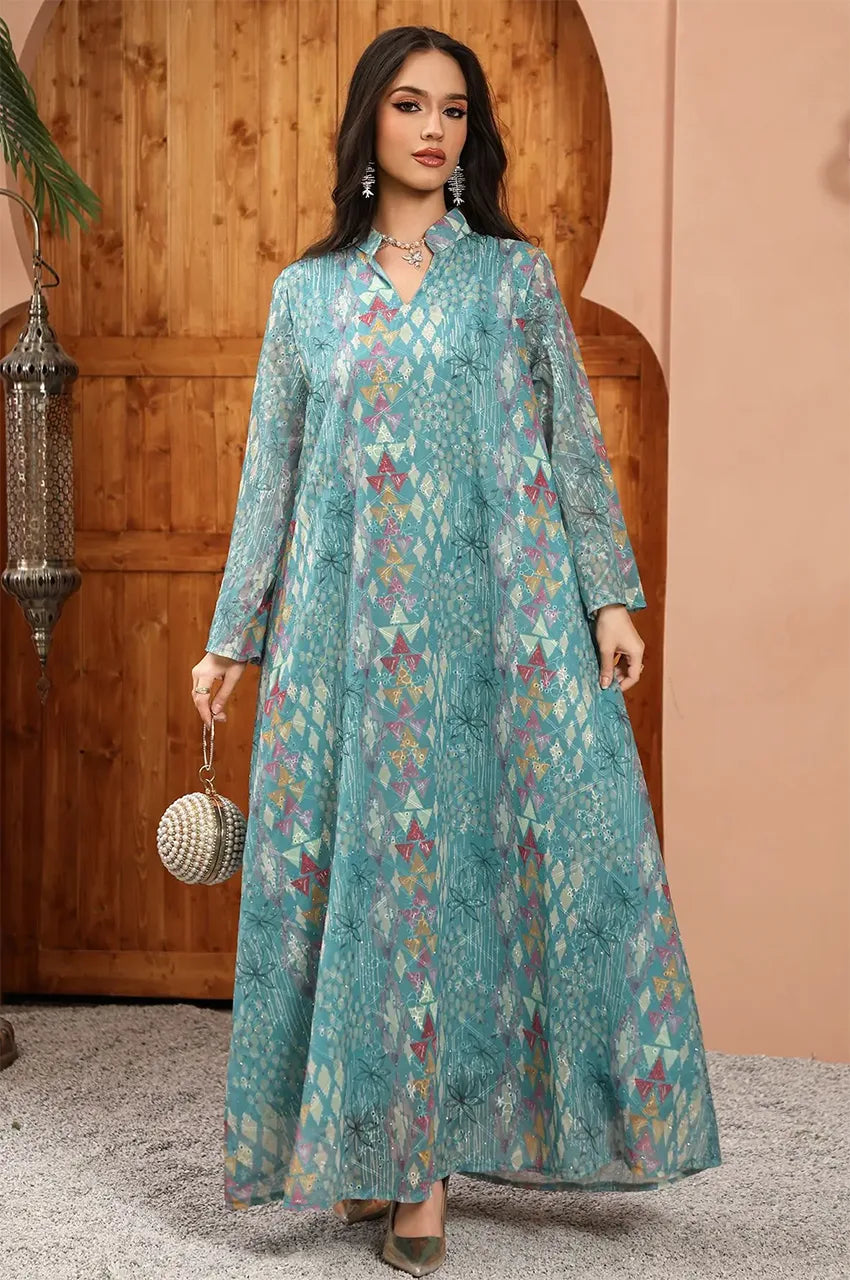 Posed view of the Tyrah light blue geometric print kaftan highlighting its elegant movement.