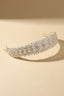 Isolated view of the Wide Gold-Tone Floral Headband on a cream background.