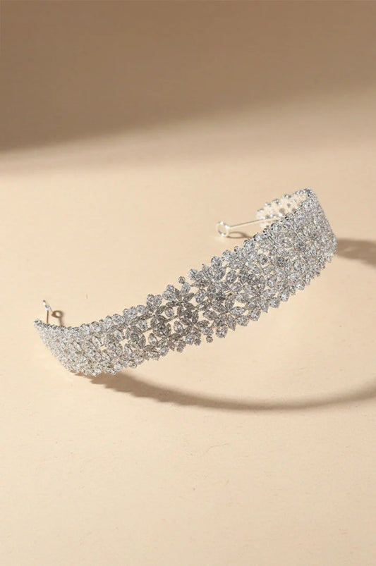Isolated view of the Wide Silver-Tone Floral Headband on a cream background.