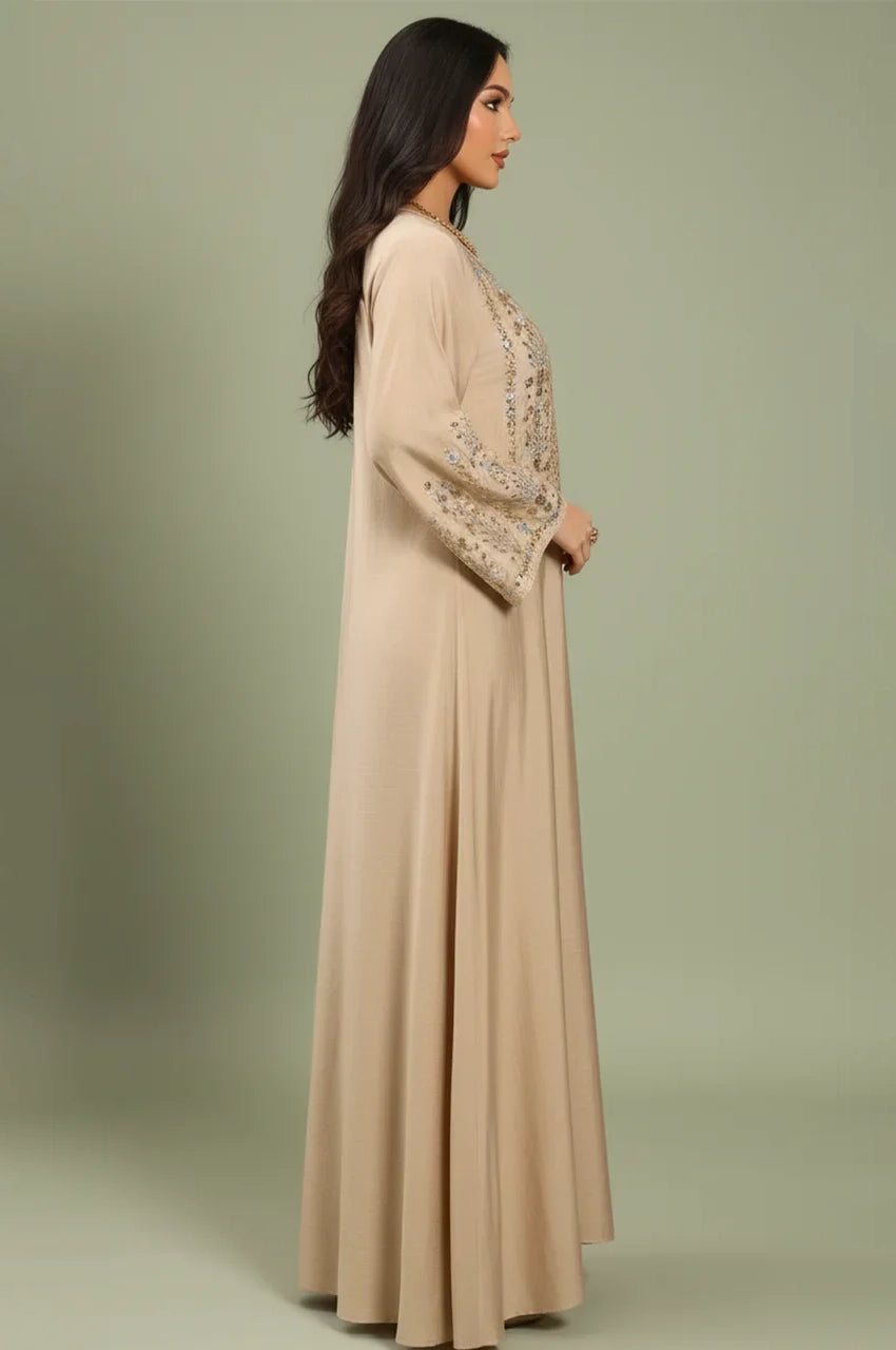 Side profile of the Zahia beige Saudi kaftan highlighting the modest floor-length silhouette.