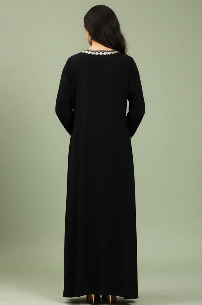 Back view of the Zahia black Saudi kaftan showing its modest floor-length drape and embroidered neckline.