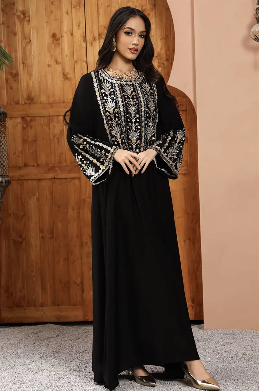 High-octane glamour Zahia black Saudi kaftan with hand-finished silver thread patterns.