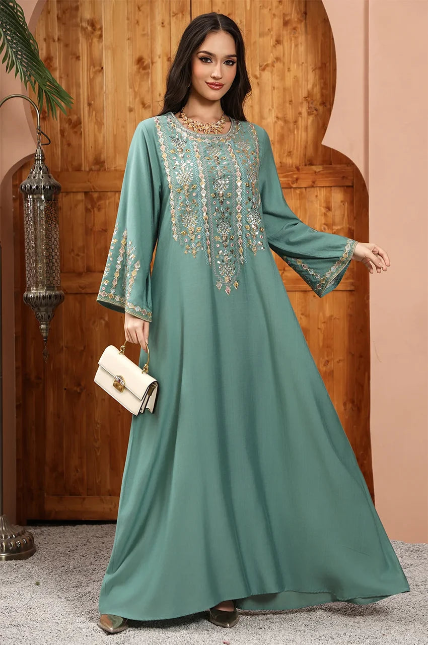 Zahia Green Saudi Kaftan styled with a luxury white handbag for a Bohemian Chic resort look.